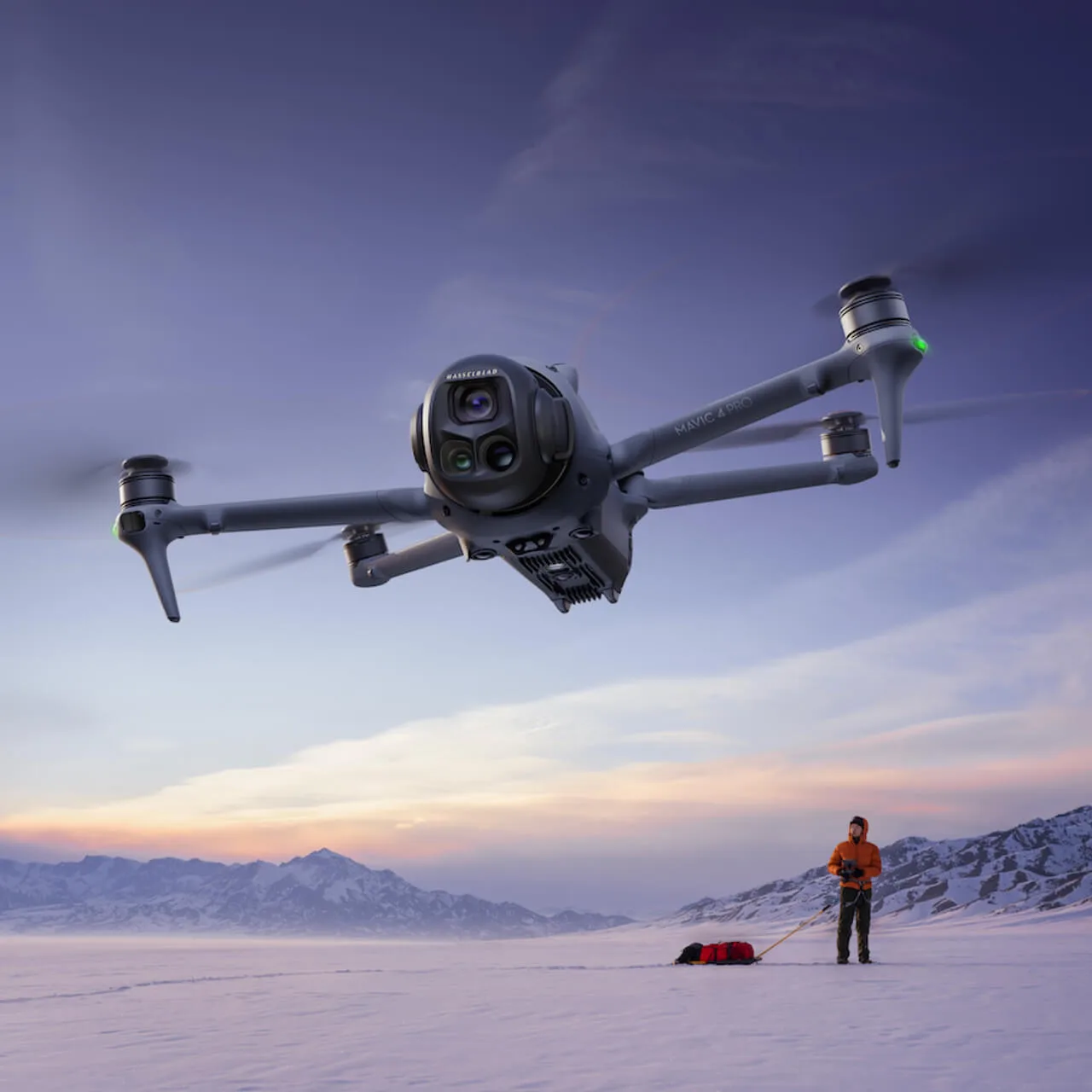 Mavic 4 Pro hovering over a snowfield at dusk while its pilot watches
